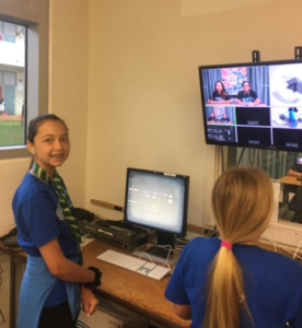 Two students handle video controls on news studio