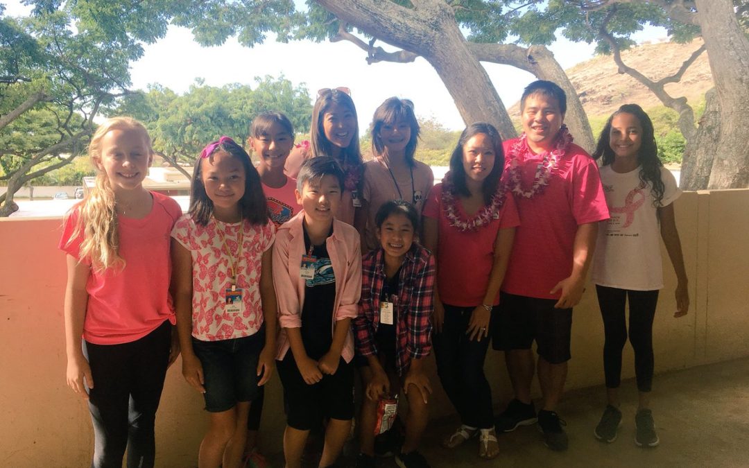 Seven students and three teachers wear pink