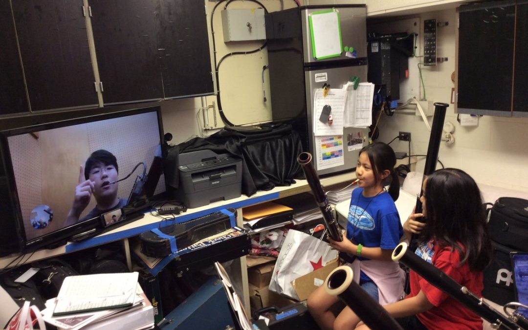 Video conference of bassoon player instructing 2 students