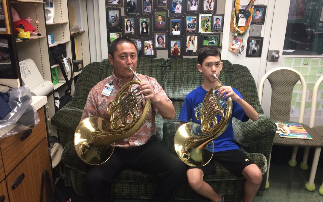 Principal and student playing french horn
