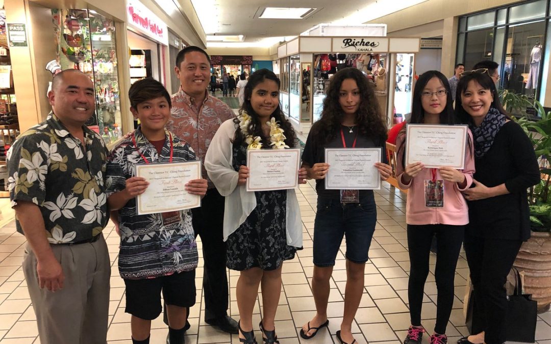 Standing with administrators and teacher, four students hold media award certificates