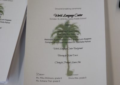 Closeup of printed program on white linen textured paper of the World Language Center groundbreaking ceremony