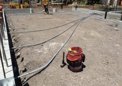 3 electrical conduits across dirt ground