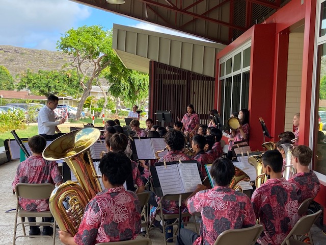 Band students performing in red aloha shirts