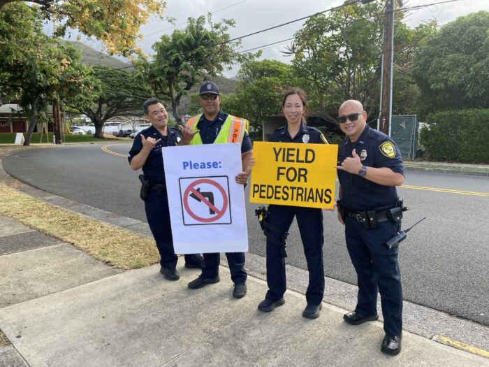 4 HPD officers holding traffic signs