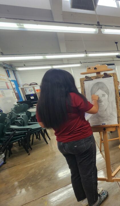 Female student working on a self portrait