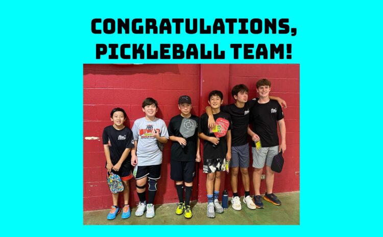 Group of male students holding pickleball rackets